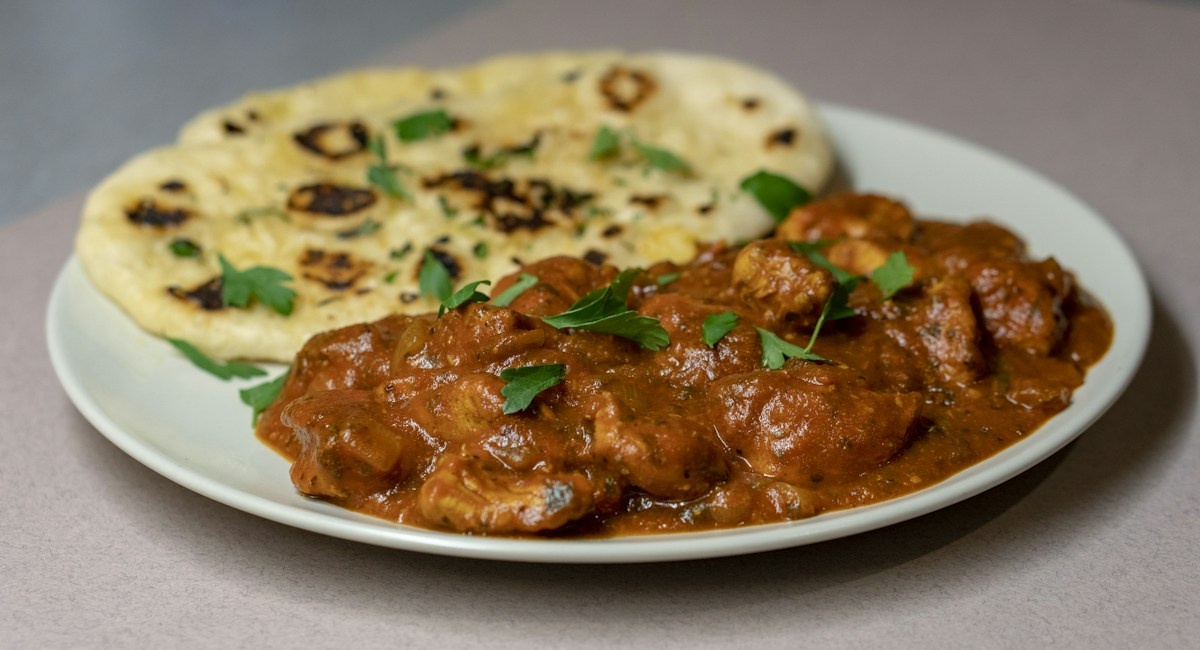 Delicious coastal prawn curry served with warm blistered roti flatbread