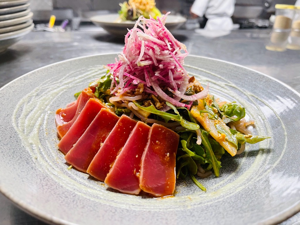 Seared Ahi tuna tataki with crisp seasonal radish and garden greens by Salt & Stilt